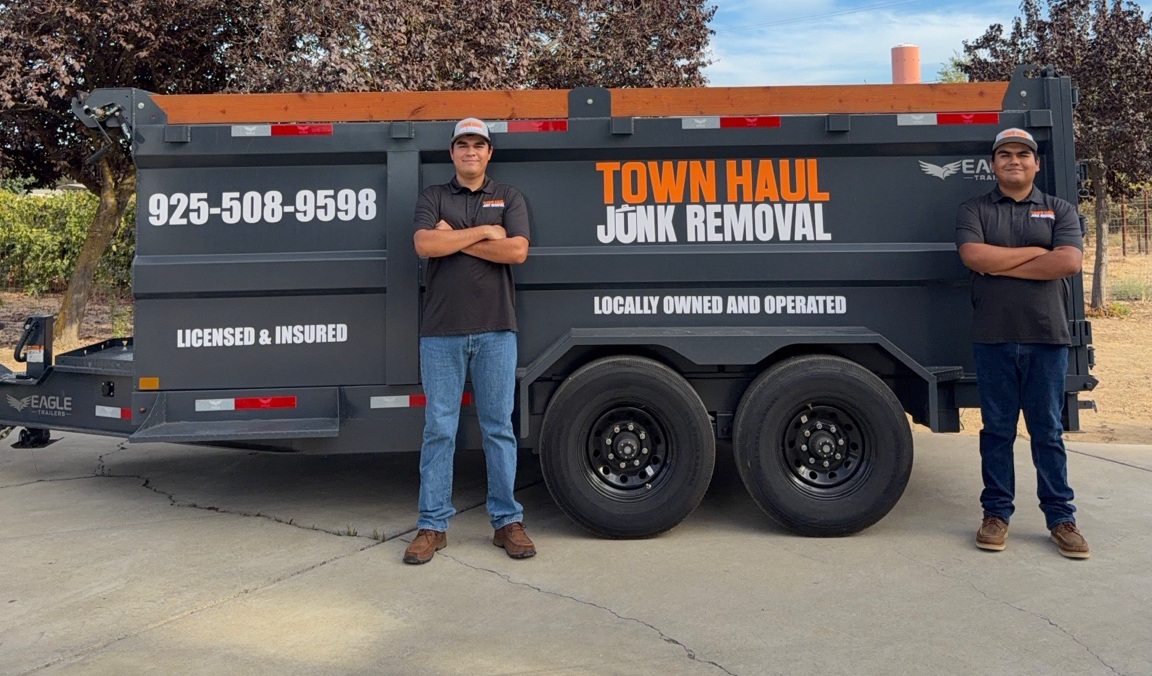 Juan and Sebastian standing beside their branded Town Haul trailer